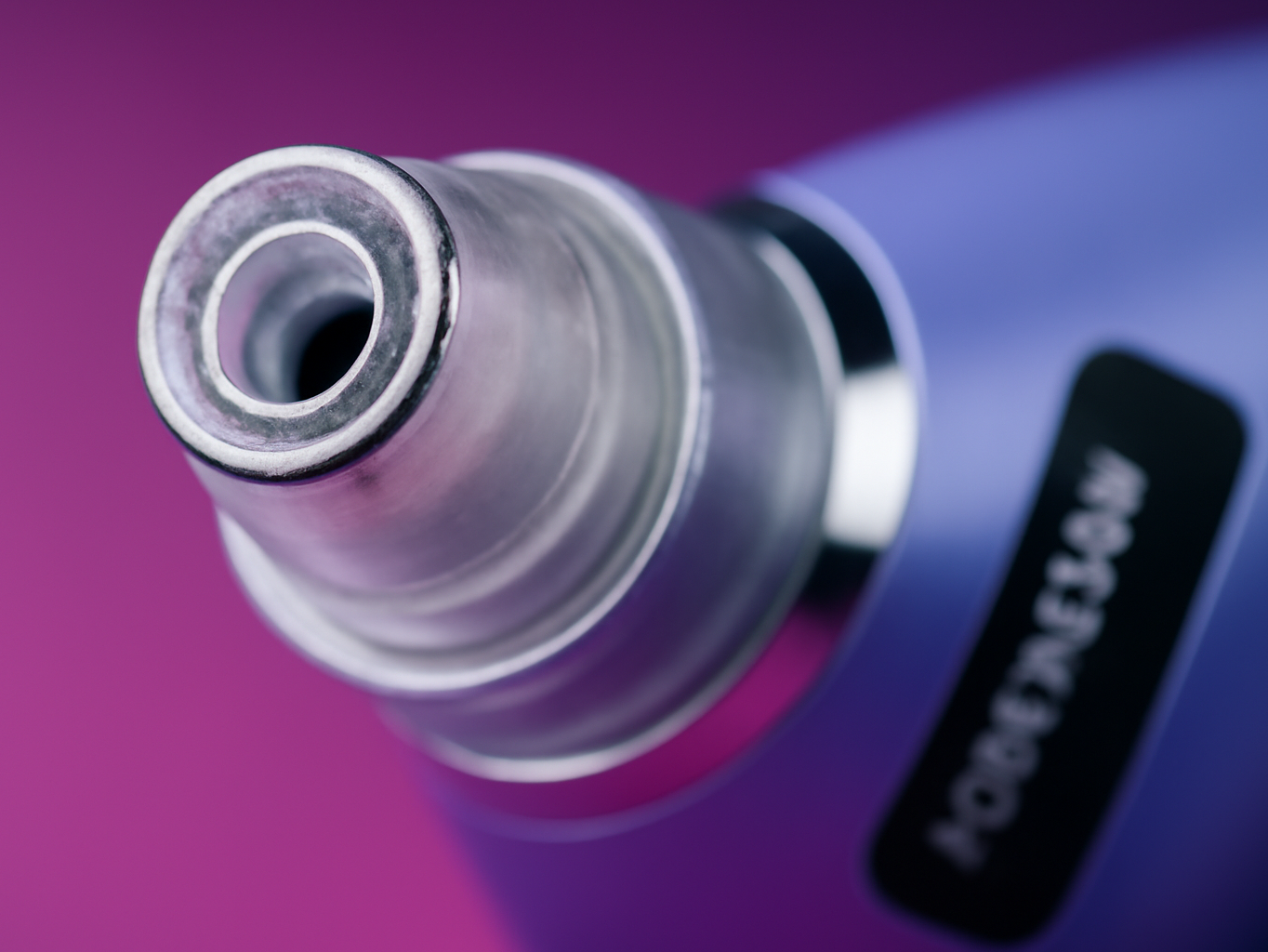 Close-up of pore vacuum suction head showing the circular opening and metallic nozzle tip in sharp detail