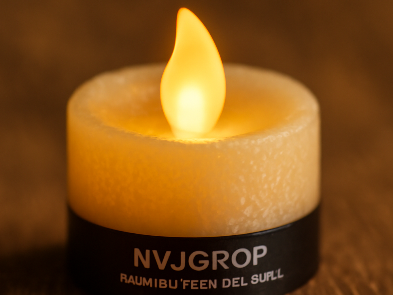 Close-up of NVJGROP rechargeable LED votive candle with glowing amber flame and textured wax surface